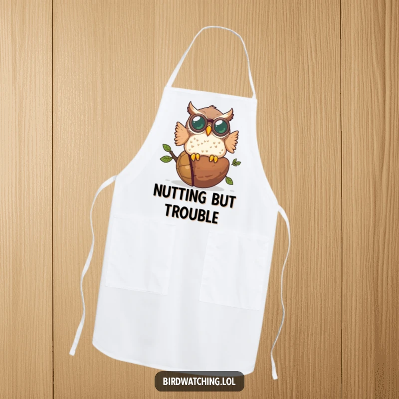 Funny kitchen apron with a plump owl in binoculars crashing into a giant acorn, a humorous design for cooking enthusiasts.