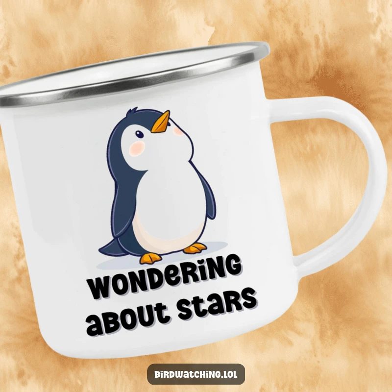 Funny camping mug with a wobbly penguin looking up at the sky with wonder, perfect for enjoying drinks outdoors with a touch of whimsy.