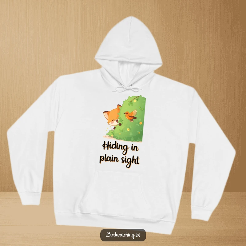 Funny Fox Hoodie: A joyful fox hiding behind a bush, watching a bird with playful intent, perfect for cozy amusement.